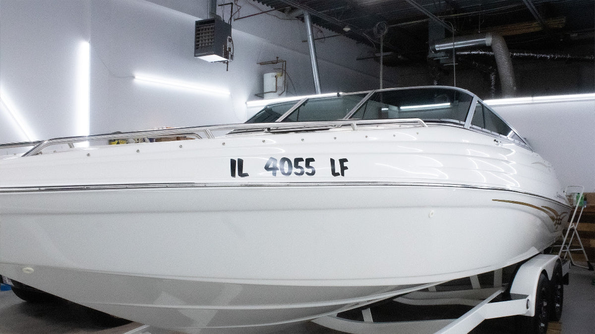 White boat with a license plate in a indoor setting