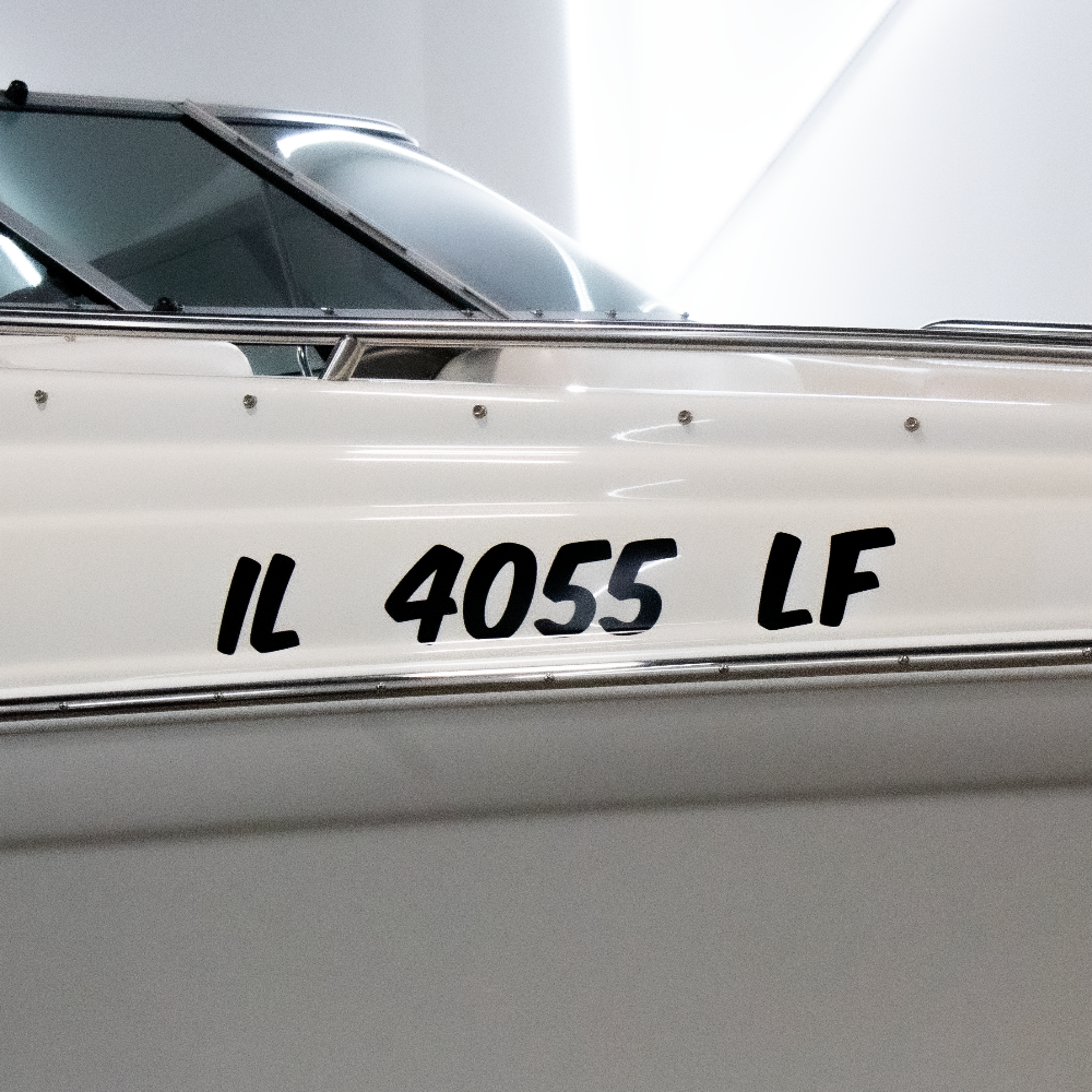 White boat with registration decal on a white background