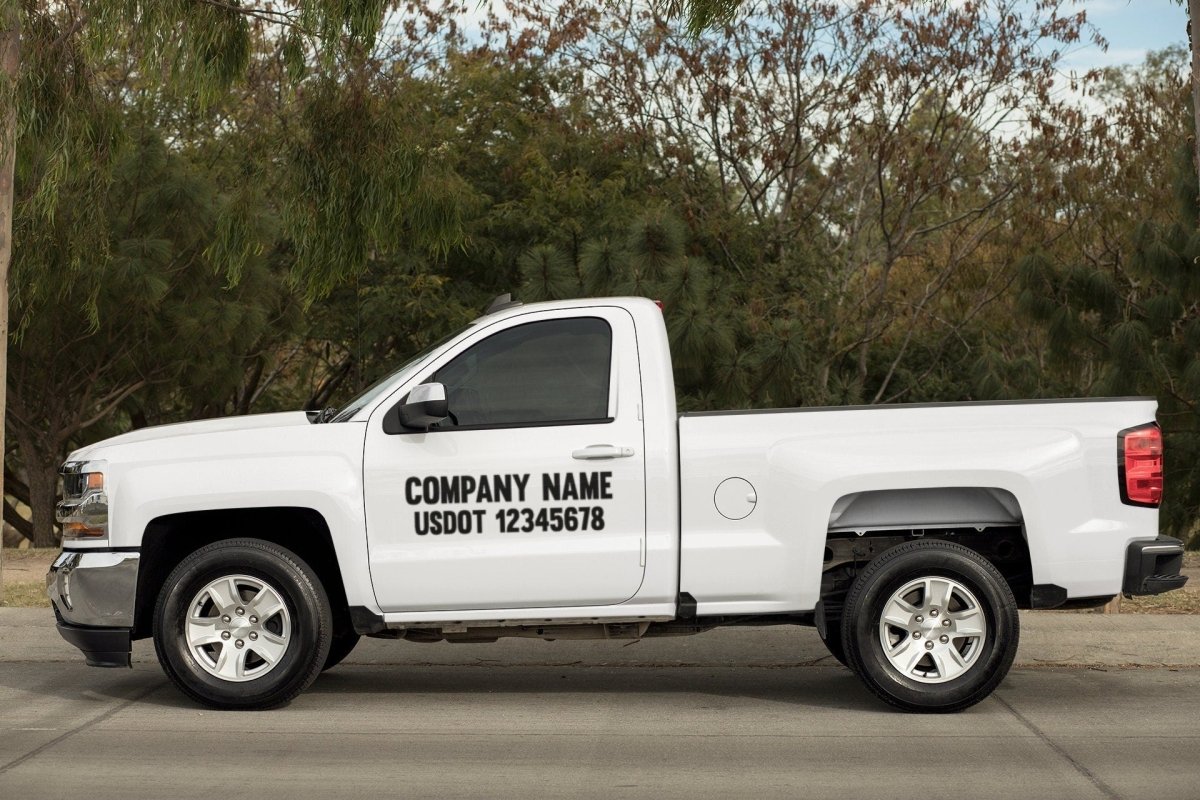 Custom Business DOT Vinyl Decal Large Format Sticker For Truck/Car/Van - Rising Sun Decals - White pickup truck with company name and US DOT number on a road with trees in the background